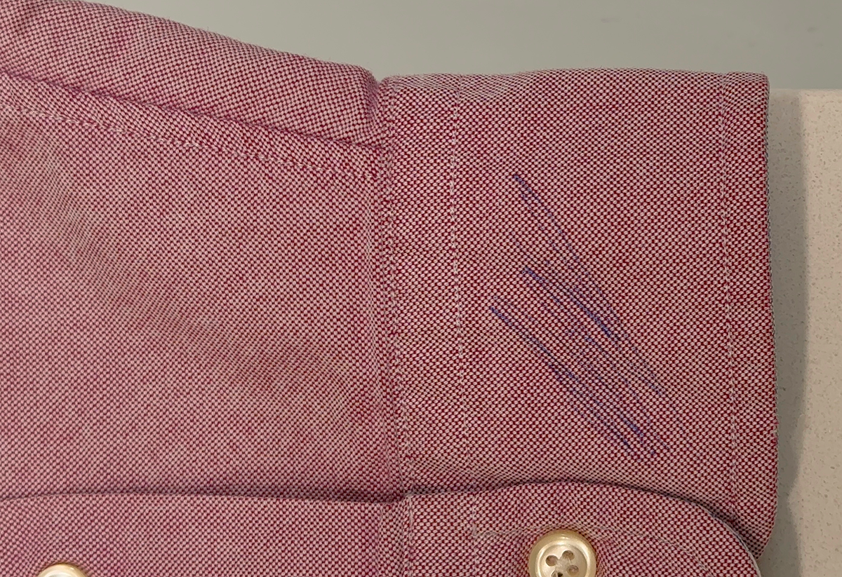 Ball-pen marks on cuffs — BEFORE